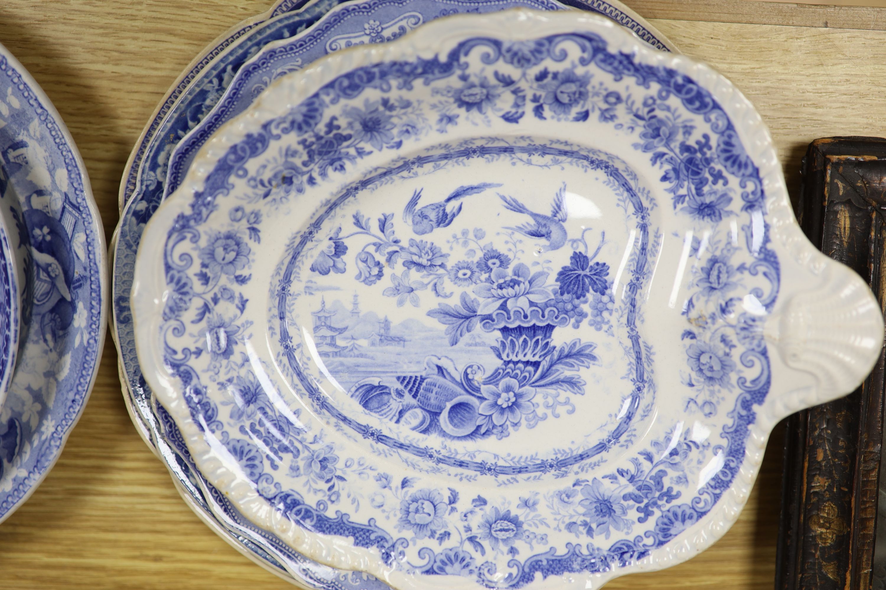 A collection of 19th and 20th century blue and white pottery plates and dishes